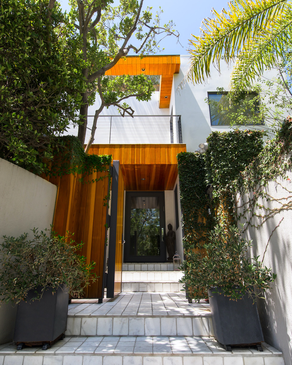 front door entrance to a home with white tiled steps leading to the front door